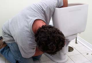 Lance is working on repairing a toilet